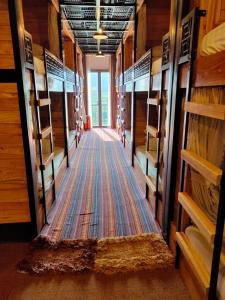 a hallway of a room with many racks of ties at Ethnic House Lounge bar & hostel in Dồng Văn