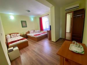 a hotel room with two beds and a table at Iorga's House in Eforie Nord +43 photos