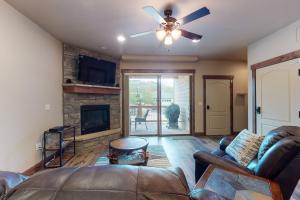 a living room with a couch and a fireplace at Riverfront Retreat & River's Edge Townhome in Silverthorne