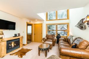 a living room with a couch and a fireplace at Cimarron Mountain Retreat in Telluride