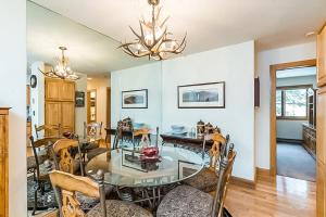 a dining room with a glass table and chairs at Cimarron Mountain Retreat in Telluride