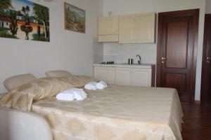a bedroom with a bed with towels on it at Appartamenti Paradise in Cannigione +31 photos