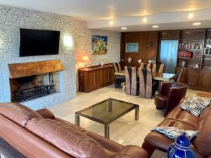 a living room with a couch and a fireplace at Espectacular Atico en Puerto Marina in Benalmádena