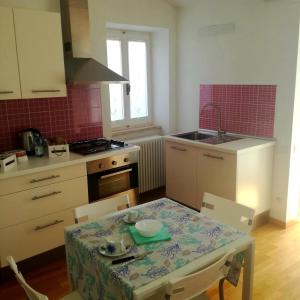 a kitchen with a table and a sink and a stove at B&B Porta Girone in Civitanova Alta +57 photos