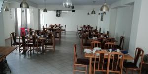 a room full of tables and chairs in a restaurant at Pod Złotym Żaglem in Karwia