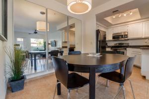a dining room with a table and chairs and a kitchen at 1 bedroom unit ground floor in Chandler