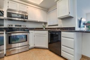 a kitchen with white cabinets and stainless steel appliances at 1 bedroom unit ground floor in Chandler