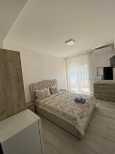 מיטה או מיטות בחדר ב-Seafront Apartments