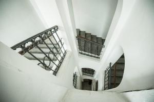 an overhead view of a staircase in a building at Charles Bridge Hostel & Apartments in Prague