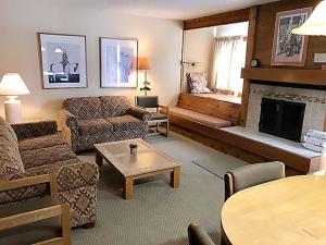 a living room with a couch and a fireplace at Jackson Hole Vacation Condominiums, a VRI resort in Wilson