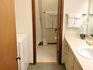 a white bathroom with a sink and a toilet at Jackson Hole Vacation Condominiums, a VRI resort in Wilson
