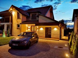 a car parked in front of a house at night at Apartman VILLA Cacak in Čačak