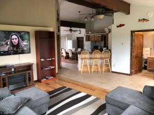 a living room with a couch and chairs and a kitchen at Alaska Home Rental in Soldotna
