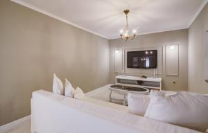 a living room with a white couch and a tv at Apartment Lara in Senj