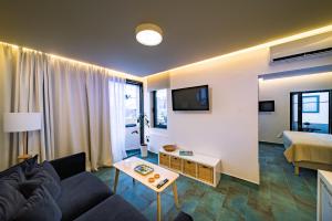 a living room with a couch and a table at Kyma Couples Getaway in Stalís