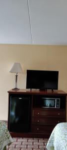 a flat screen tv sitting on top of a bed at Days Inn by Wyndham Dickson in Dickson