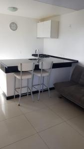 a kitchen with a sink and two chairs and a counter at ECO PARADISE _ CUMBUCO BOUTIQUE in Cumbuco