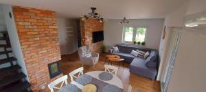 a living room with a couch and a table and chairs at Osada Wieprz in Zalewo