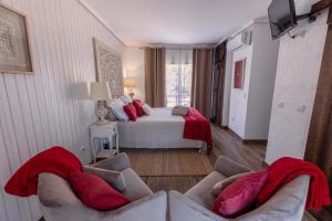 a bedroom with a bed and two couches in a room at Casa da Mó - Douro in Armamar