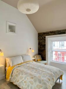 a bedroom with a bed and a stone wall at Room 1 Camp Street B&B in Oughterard