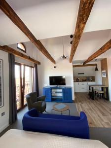 a living room with a blue couch and a table at Willa Oktawia in Niechorze