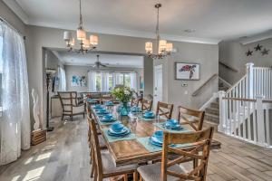 a dining room with a long table and chairs at Breezy Myrtle Beach Getaway, 1 Block to Beach! in Myrtle Beach