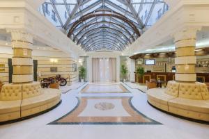 a lobby of a building with a glass ceiling at Ambassador in Saint Petersburg