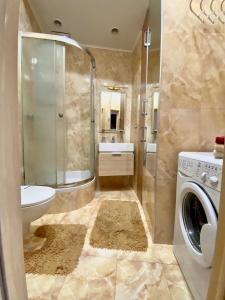 a bathroom with a washing machine and a sink at Most City Kos in Dnipro