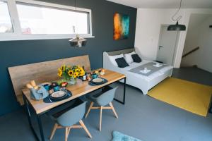 a small room with a table and a bed at Wave Penthouses in Neusiedl am See