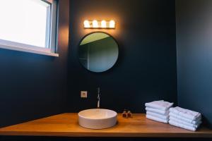 a bathroom with a sink and a mirror on a counter at Wave Penthouses in Neusiedl am See