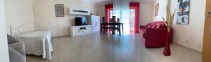 a living room with a couch and a chair and a television at Fantastic Fatima Apartment in Vila Real de Santo António