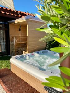 a jacuzzi tub in the backyard of a house at Sky Luxury Suite in Keszthely