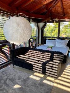 a bedroom with a bed and a large chandelier at Sky Luxury Suite in Keszthely +24 photos