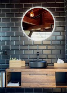 a bathroom with a sink and a mirror at Sky Luxury Suite in Keszthely