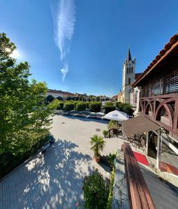 an empty courtyard with a building and a church at Sky Luxury Suite in Keszthely