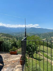 a balcony with a fence and a view of the mountains at Agriturismo Flarà in Basciano