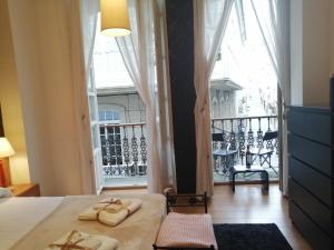 a bedroom with a bed and a large window at BERAMAR APARTMENT in Viveiro