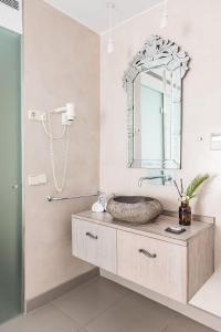 
a bathroom with a sink and a mirror at Hotel Planamar in Platja  d'Aro
