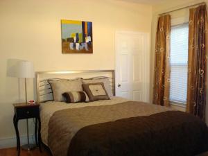 a bedroom with a large bed with two pillows at Bowers House Bed and Breakfast in Somerville