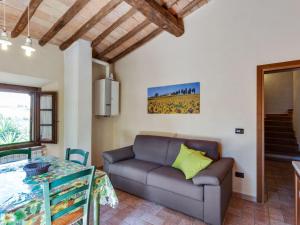 a living room with a couch and a table at Tranquil Holiday Home in Volterra with Swimming Pool in Volterra