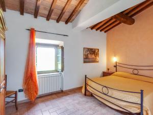 a bedroom with a bed and a window at Tranquil Holiday Home in Volterra with Swimming Pool in Volterra