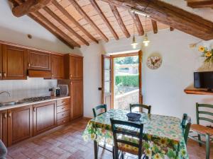 a kitchen with a table and a table and chairs at Tranquil Holiday Home in Volterra with Swimming Pool in Volterra