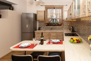 a kitchen with a table with a bottle of wine at G and A House in Póros Kefalonias