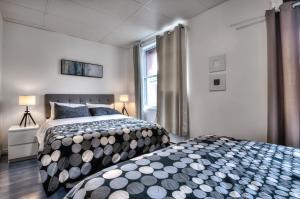 a bedroom with two beds and a window at 100 METERS to SUBWAY - Montcalm condos in Montreal