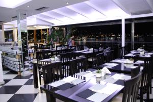 a restaurant with tables and chairs with a view of the city at Republika Hotel in Sarandë