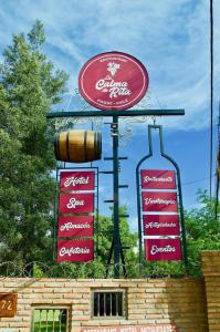 a sign for a restaurant with three signs at Hotel La Calma De Rita - Pirque in Pirque