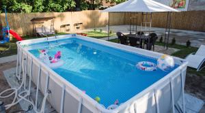 a swimming pool with two toy boats in it at D&D apartments in Subotica