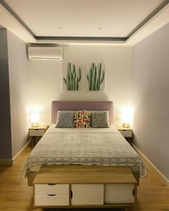 a bedroom with a large bed with two lamps at Private Sea view house Belonika in Benitses