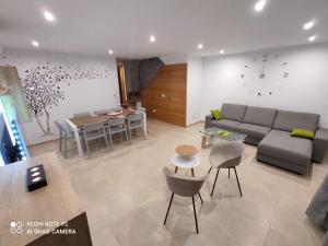 a living room with a couch and a table at CHALET ADOSADO DULCINEA Alcossebre in Alcossebre