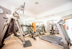a gym with treadmills and machines in a room at Aquamar Albufeira Aparthotel in Albufeira